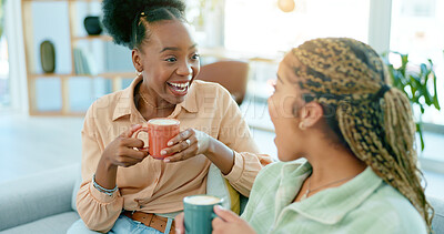 Buy stock photo Happy, talking and women with coffee on the sofa for gossip, secret or conversation in a house. Excited, relax and a black woman with a girl or friends with communication, tea and story on the couch