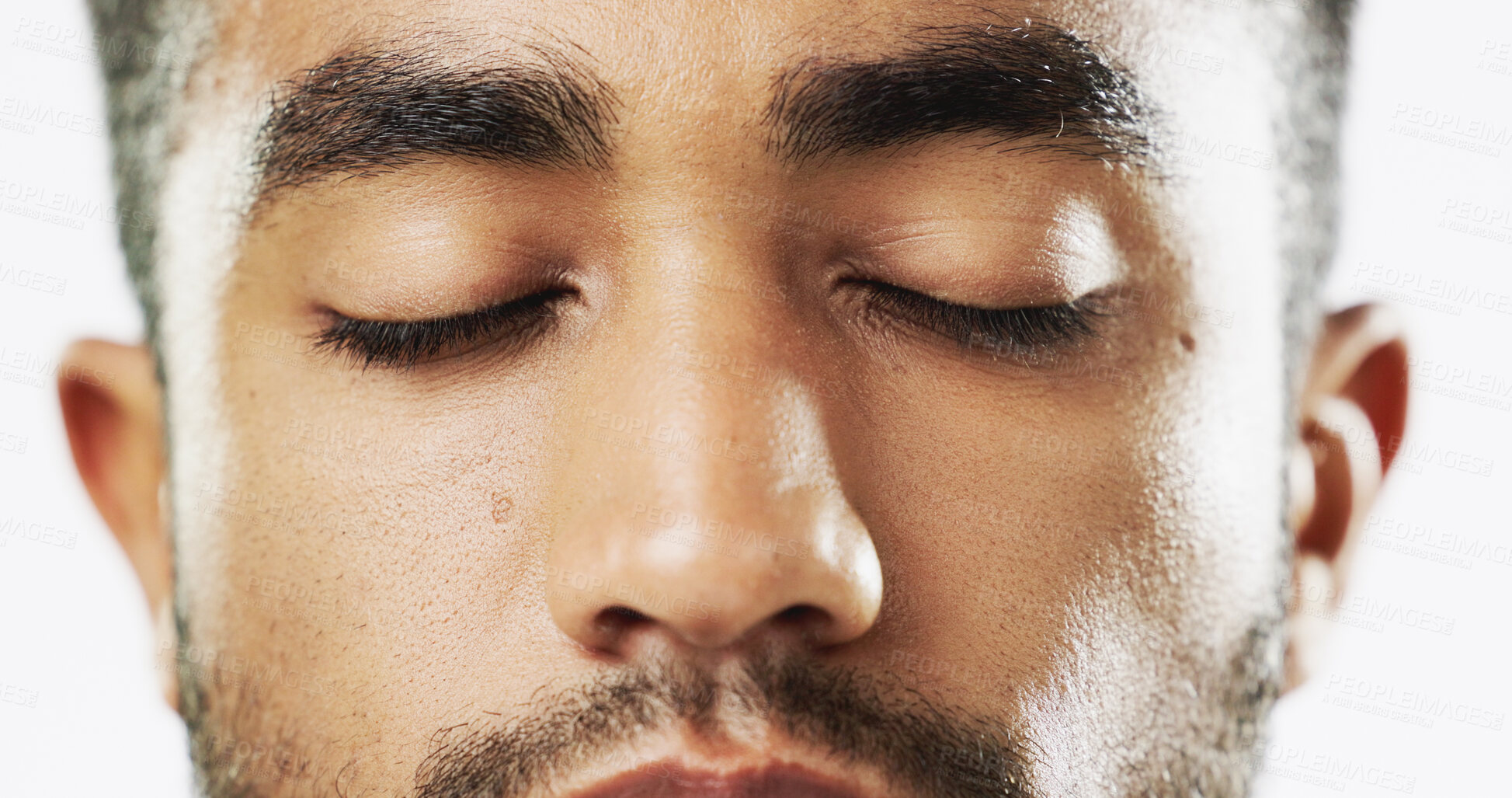 Buy stock photo Closeup, face and serious man in studio for skincare eyes closed, confident and handsome against white background. Zoom, young and portrait of Indian male model with wellness, beauty or cosmetic routine isolated