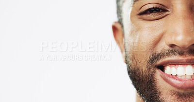 Face, closeup and man in studio for skincare, happy and laughing against white background. Zoom, smile and portrait of Indian male model excited for wellness, beauty and cosmetic care while isolated