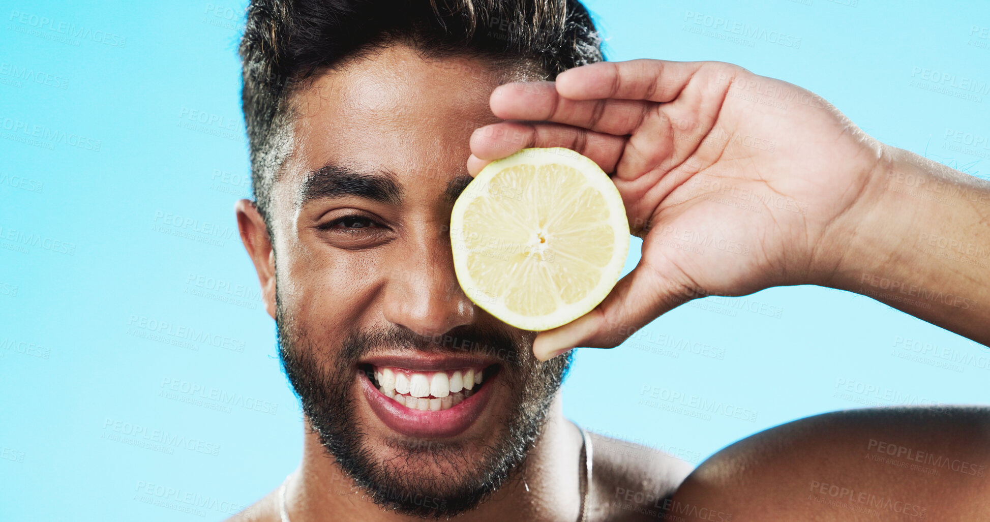 Buy stock photo Man, portrait and lemon fruits for beauty, vitamin c or vegan dermatology in studio on blue background. Face of happy indian model, citrus and nutrition of natural skincare, detox or healthy benefits