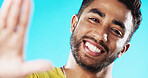 Selfie, laughing and face of a man with a smile isolated on a blue background in a studio. Happy, cheerful and portrait of a young guy taking a photo, smiling and posing for a picture on a backdrop