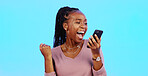 Wow, happy and excited black woman with phone reading  email news of bonus, promotion or announcement in studio. Winning, prize notification and African girl celebrating with smile on blue background