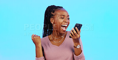 Wow, happy and excited black woman with phone reading email news of bonus, promotion or announcement in studio. Winning, prize notification and African girl celebrating with smile on blue background