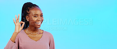 Perfect, sign and woman with okay hand gesture smile and happy with mockup space isolated in a studio blue background. Portrait, satisfaction and African American woman with support and winning emoji