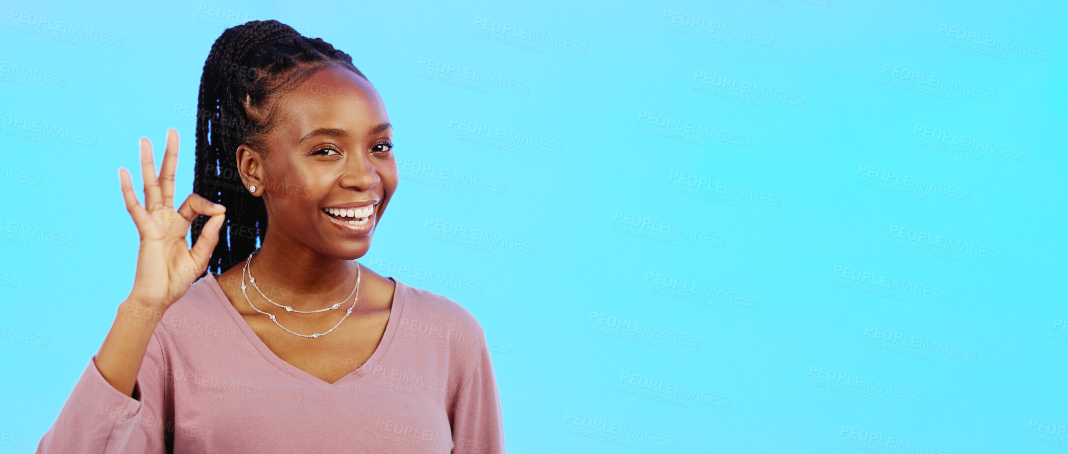 Buy stock photo Black woman, portrait and OK sign for agreement, support with mockup space and smile on blue background. Trust, feedback or review with hand gesture, like emoji or yes, success and pride in studio