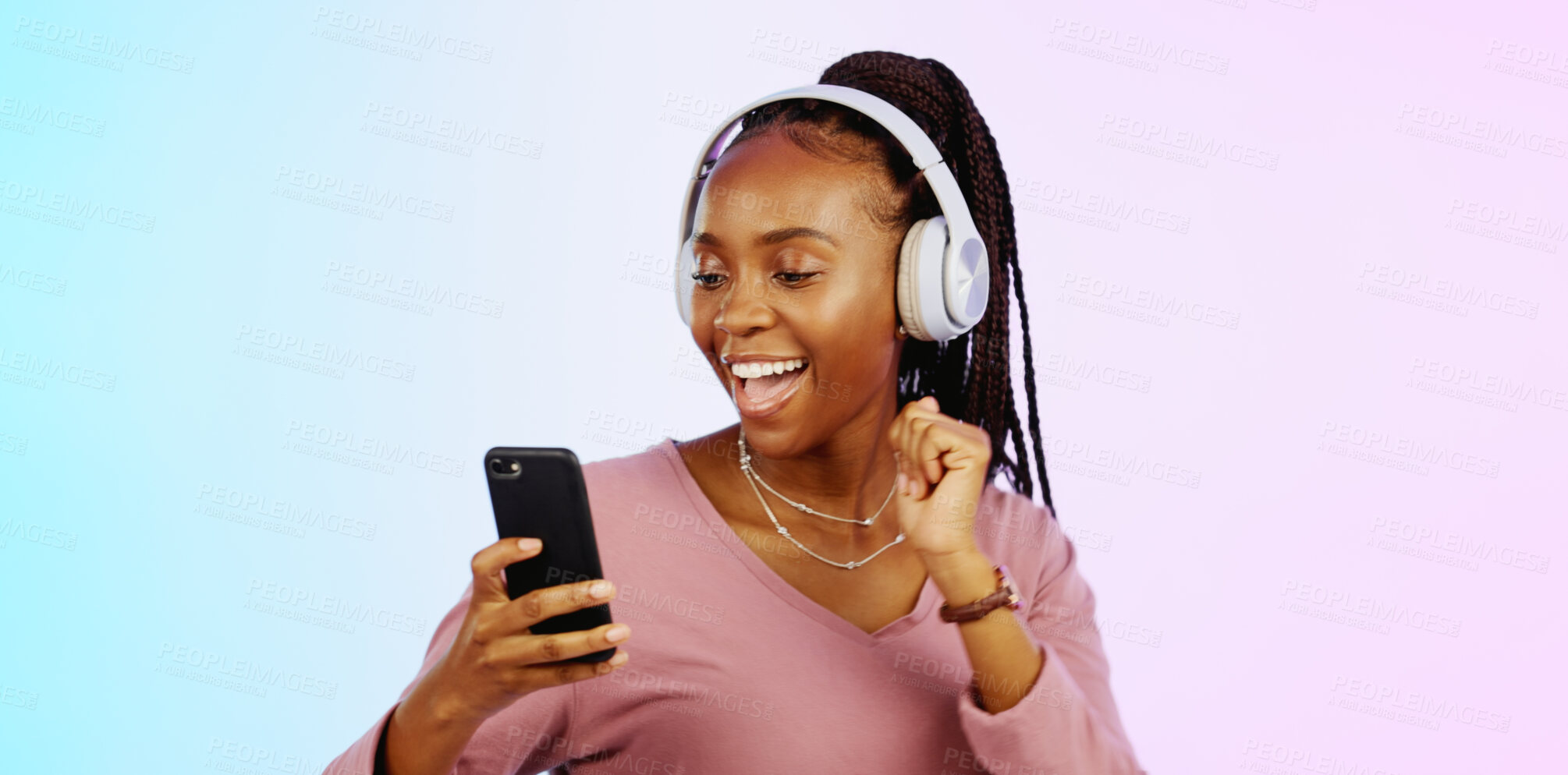 Buy stock photo Dance, music and headphones with black woman, phone or smile in studio for streaming online radio. Pink, blue background or happy African girl listening to track, songs or audio podcast on mobile app