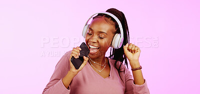 Sing, dance and black woman with headphones music microphone isolated on a studio background. Fun, happy and funky African girl listening to audio, radio or songs while singing and dancing on a backdrop