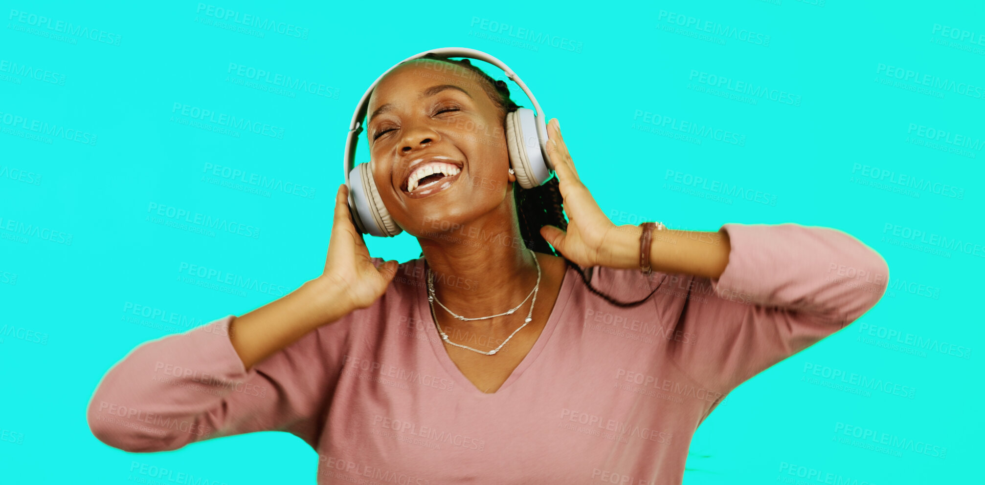 Buy stock photo Smile, black woman and music headphones in studio for freedom, party and hearing audio song on blue background. Happy young model listening to multimedia podcast, sound or radio subscription to relax