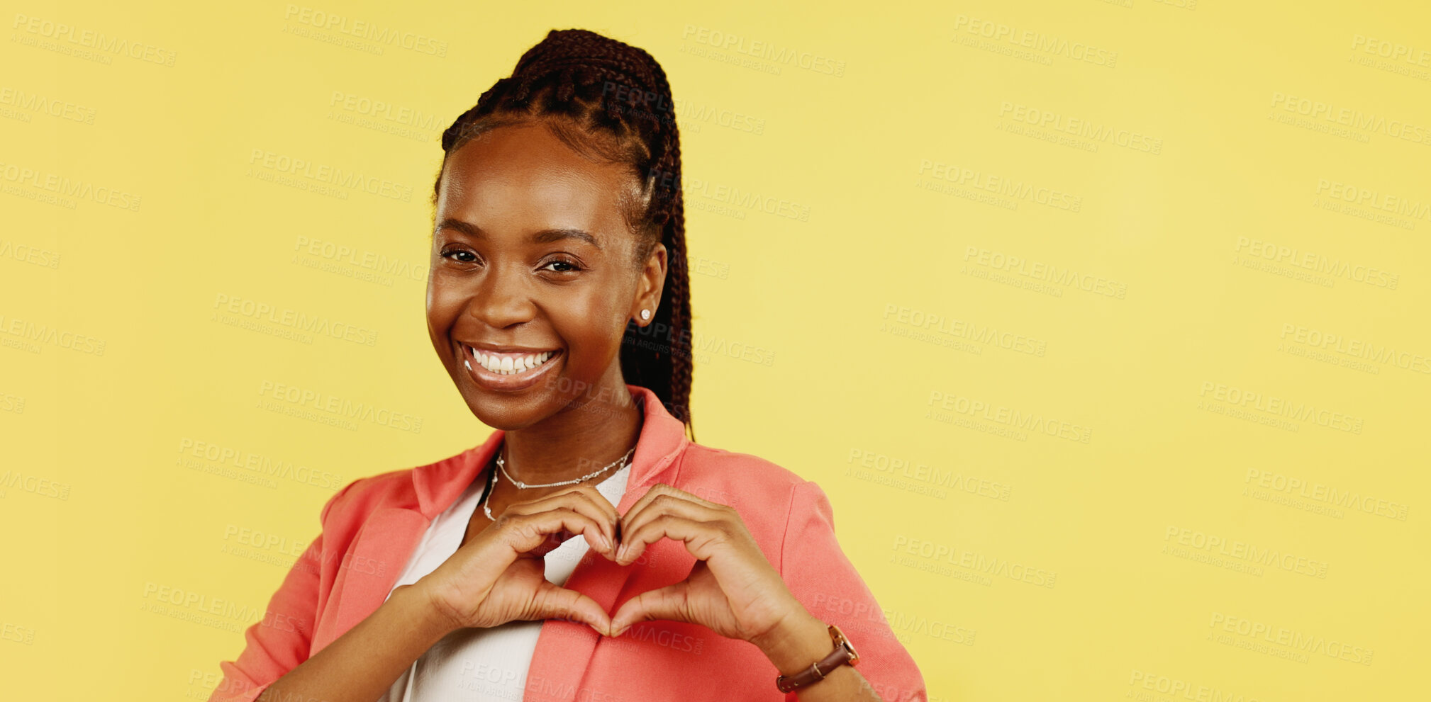 Buy stock photo Heart hands, portrait and love sign with black woman in studio, kindness and feedback on yellow background. Gratitude, smile and emoji with support, care and charity with health and wellness 