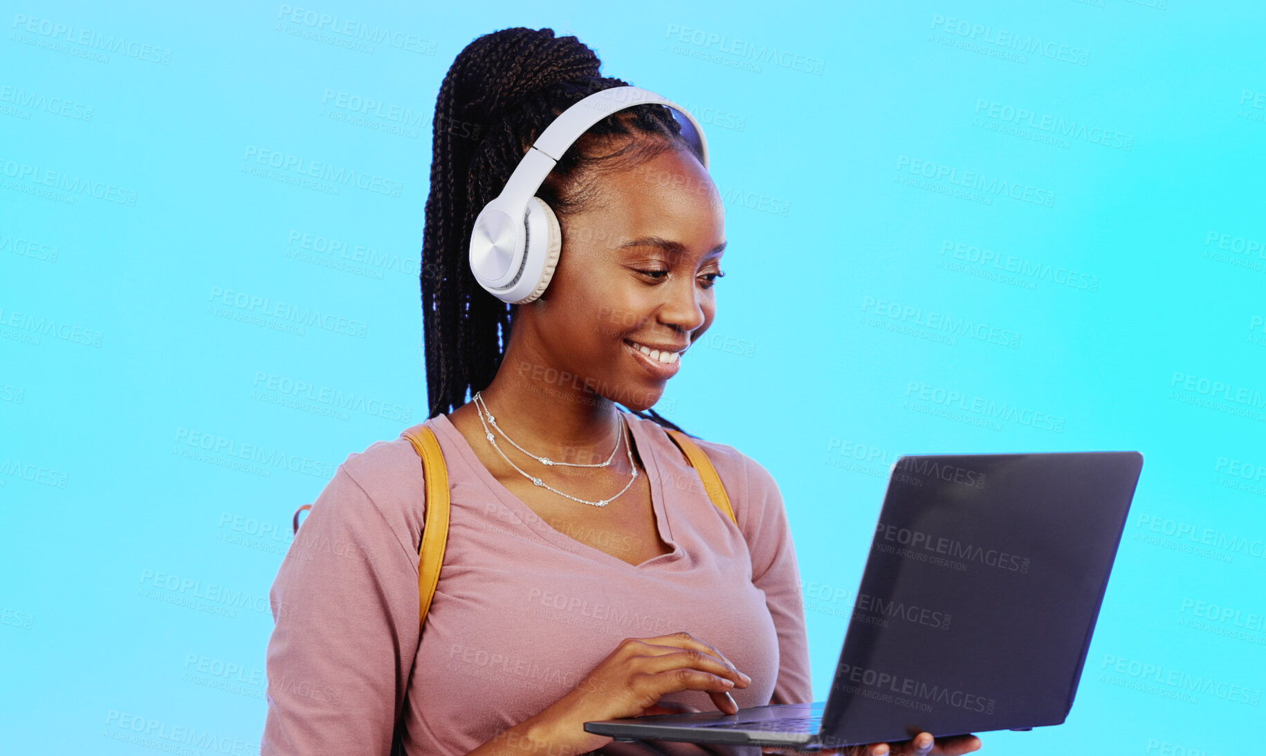 Buy stock photo Student, headphones and laptop for online education, e learning and listening to music or audio streaming in studio. Happy black woman on computer, college search or virtual school on blue background