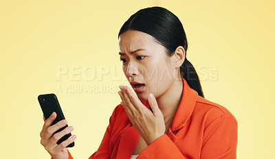 Asian woman, phone and shocked for bad news, loss or disbelief against a studio background. Female face in shock with facial expression on smartphone for terrible text, message or alert on mockup