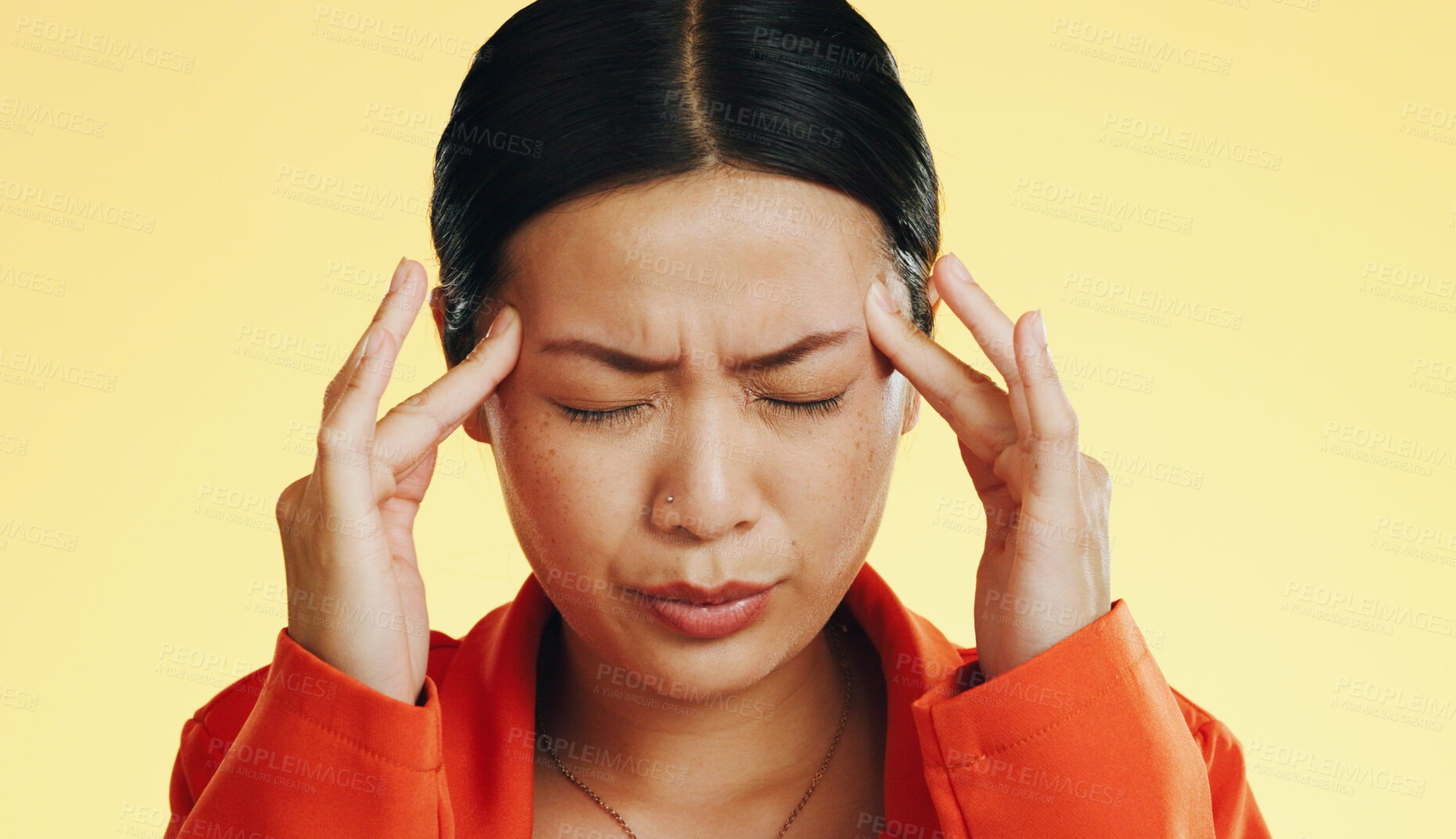 Buy stock photo Woman, headache and breathing through pain, stress and health fail with burnout and brain fog on yellow background. Asian model massage temple, frustrated with vertigo and fatigue, migraine in studio