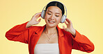 Dance smile, music headphones and Asian woman in studio isolated on a yellow background. Technology, podcast or happy female streaming, listening and dancing to radio, song and audio, sound and album