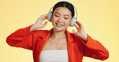 Dance smile, music headphones and Asian woman in studio isolated on a yellow background. Technology, podcast or happy female streaming, listening and dancing to radio, song and audio, sound and album