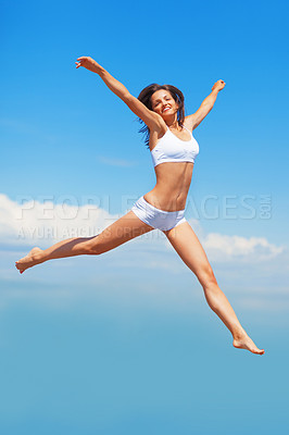 Buy stock photo Freedom, portrait and body of woman jump in underwear on blue sky background with energy, happy or mockup. Smile, jumping and girl model in air in celebration, health or achievement and summer fun