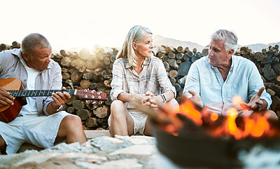 Buy stock photo Senior, adventure and fun wellness hiking group of friends, relaxing or taking a break by the campfire after walking on outdoors mountain trip. Elderly explorers resting on camping getaway trip