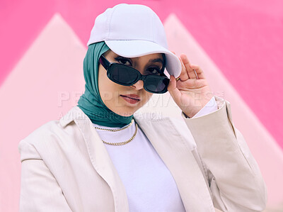 Buy stock photo Muslim woman, fashion and sunglasses in portrait by wall, gen z aesthetic or beauty with art deco in city. Young islamic girl, student and clothes with pride, freedom or cap for travel in Dubai metro