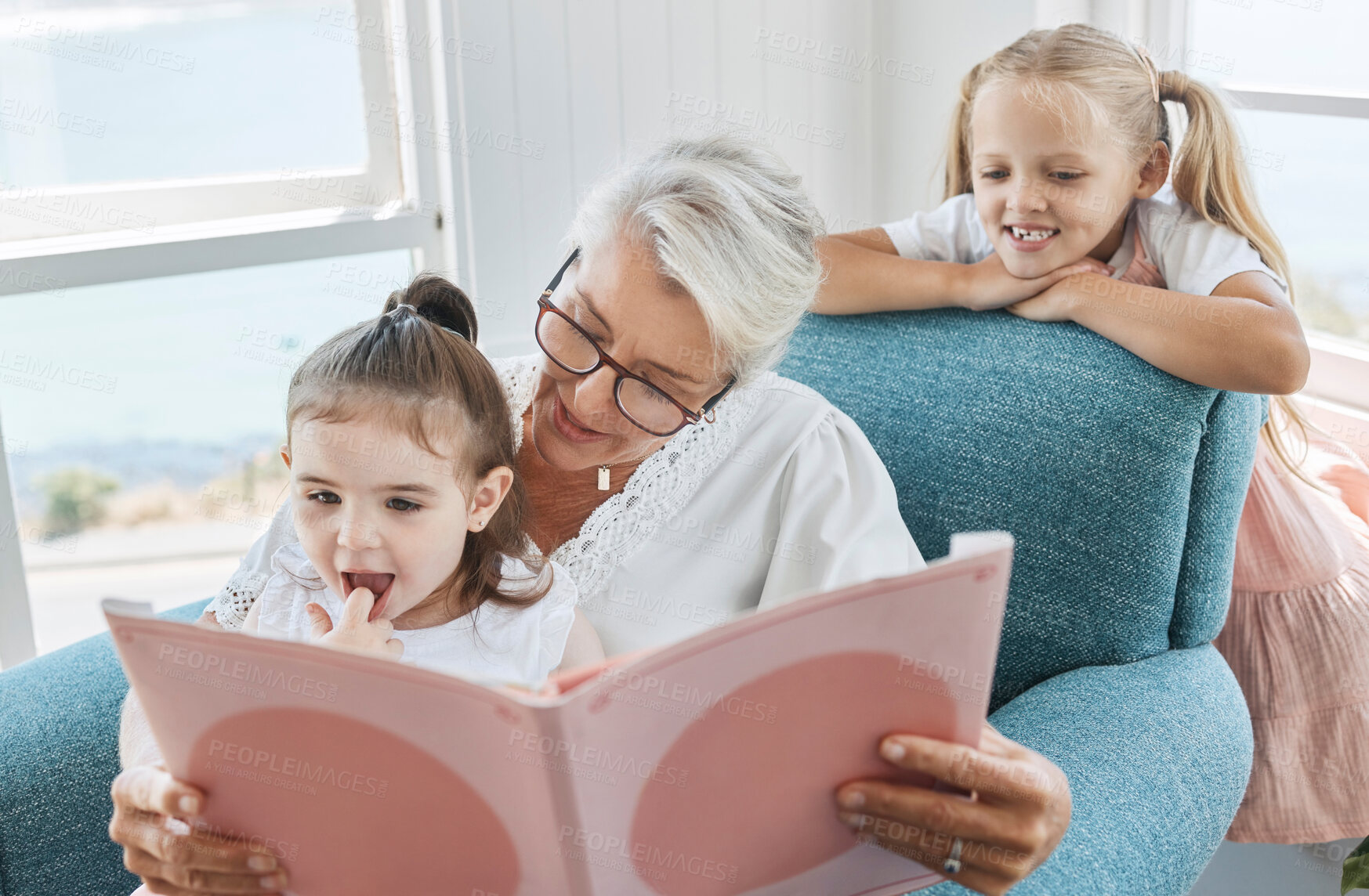 Buy stock photo Book, family and children with a grandmother and girl kids reading a story in a home living room together. Retirement, love and learning with an elderly female and sister siblings bonding in a house