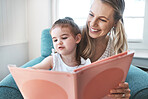 Book, family and love with a mother and daughter reading a story on a couch in the living room of their home together. Children, love and education with a woman and daughter bonding over a storybook