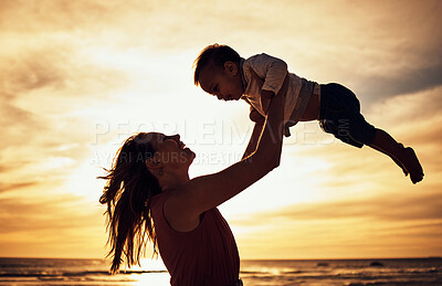Buy stock photo Family, silhouette and beach sunset with mother and baby against golden sky with love, care and support while on vacation in summer. Woman and child happy by sea for travel, adventure and freedom