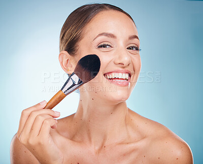 Buy stock photo Face portrait, skincare and woman with makeup brush in studio isolated on a blue background. Product, cosmetics tool and aesthetics of happy female model with accessory to apply foundation for beauty