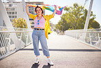 Rainbow, flag and lgbt woman portrait of a person with human rights, sexuality and equality support. Freedom, smile and gen z female on a urban city bridge with celebration of lgbtq with happiness