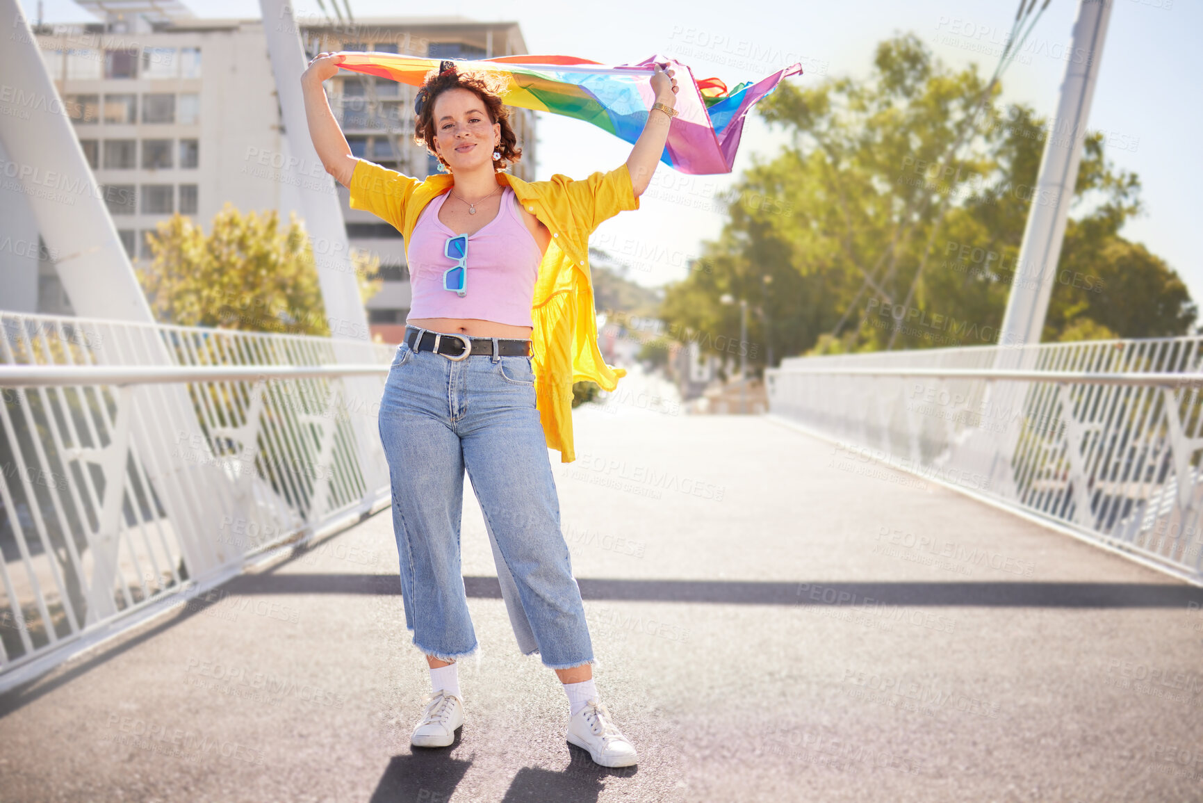 Buy stock photo Rainbow, flag and lgbt woman portrait of a person with human rights, sexuality and equality support. Freedom, smile and gen z female on a urban city bridge with celebration of lgbtq with happiness