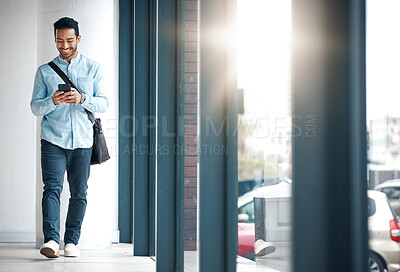 Buy stock photo Professional man with phone, communication with typing or scroll through social media with smile. Happy young male, reading text and contact with network, technology and creative employee at startup