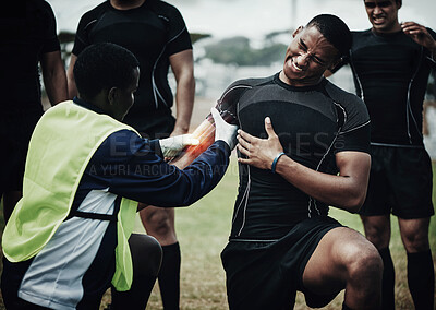 Buy stock photo Rugby player, muscle injury and field with pain, team doctor and broken bone in game, overlay and helping hand. Athlete, emergency or accident with sports medic, torn bicep and red glow for fitness