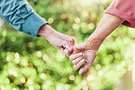 Senior couple, garden and holding hands with support and love in outdoor with commitment. Together, hand and elder person for retirement in close up with friends walking in nature for bonding.