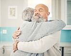 Love, romance and senior couple hugging in the kitchen together in their modern house. Happy, sweet and elderly man embracing his wife with care, affection and happiness for bonding in their home.