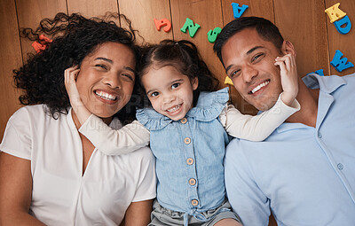 Buy stock photo Happy, love and above portrait of a family with care, relax and bonding together on the lounge floor. Smile, fun and a child with affection for parents in the living room in a house for playing