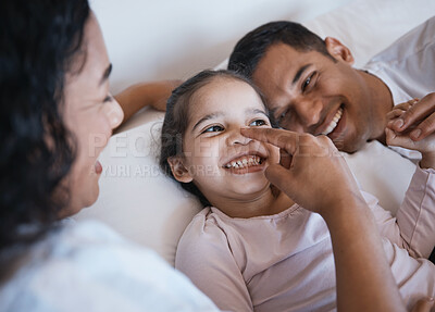 Buy stock photo Love, smile and happy family in a bed laughing, bonding and playing in their home together. Face, playful and girl child with parents in a bedroom, having fun and enjoying a weekend in their house