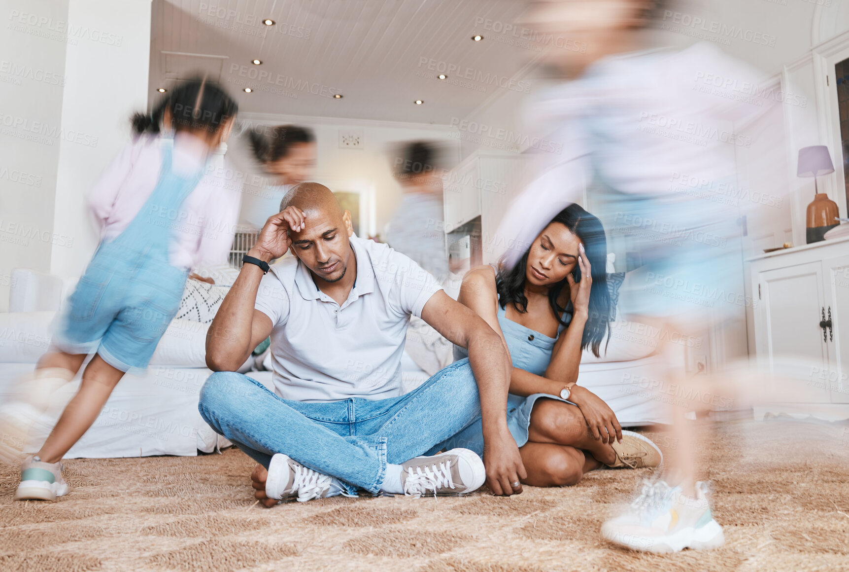Buy stock photo Running, home and parents with stress, kids and tired with burnout, anxiety and noise in a living room. Mother, father and energetic children in a lounge, adhd and fatigue with motion and headache