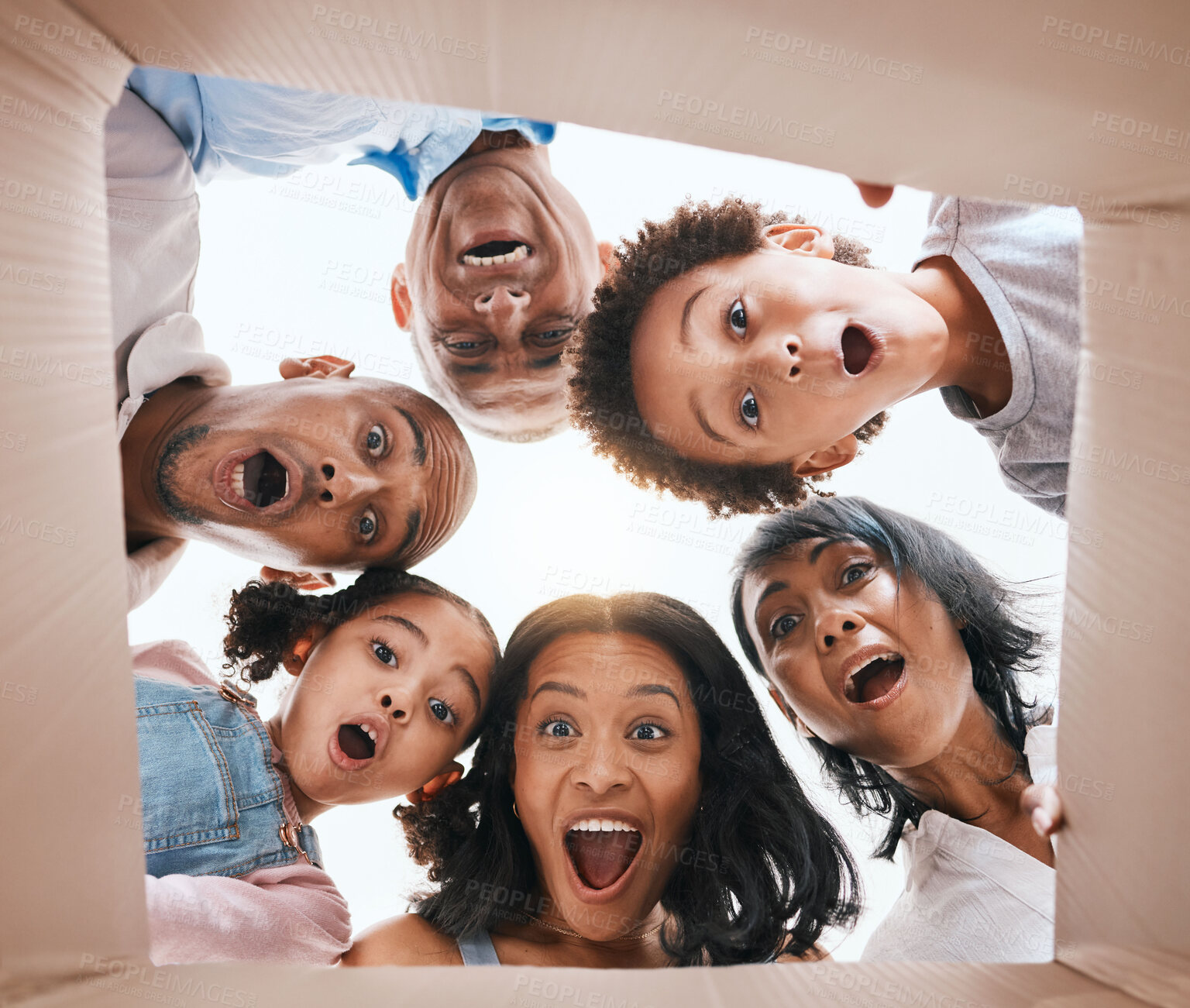 Buy stock photo Family, open box and surprise from below with smile, portrait and circle for present, together and excited in home. Happy men, women and children with package, gift and wow with grandparents in house