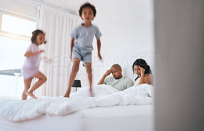 Buy stock photo Young kids, jump and parents on bed with playing, game and excited in family house in morning. Naughty sibling children, mother and father in bedroom with bond, love and childhood development in home
