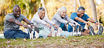 Fitness, stretching and senior people in park for healthy body, wellness and active workout outdoors. Retirement, sports and men and women stretch legs on grass for exercise, training and warm up