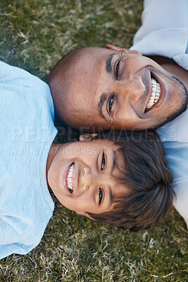 Buy stock photo Family, portrait and lying on grass in backyard with father and kid together with love. Face, top view and dad with child on holiday with with parent support and care on a lawn with happy smile