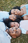 Family, happy portrait and lying on grass in garden with mother, father and kids together with love. Face, top view and dad with mom and children with parent support and care on a lawn with smile