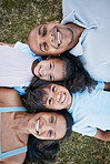 Family, portrait and lying on grass in garden with mother, father and kids together with love. Face, top view and dad with mom and children with parent support and care on a lawn with happy smile