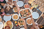 Aerial, food and family at outdoor table for birthday, celebration and party, eating together. Top view, social event and parents with children at picnic with meal, lunch and bonding to celebrate