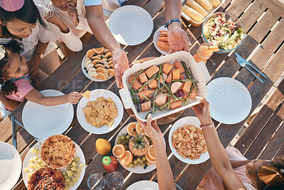 Buy stock photo Aerial, food and family at outdoor table for birthday, celebration and party, eating together. Top view, social event and parents with children at picnic with meal, lunch and bonding to celebrate