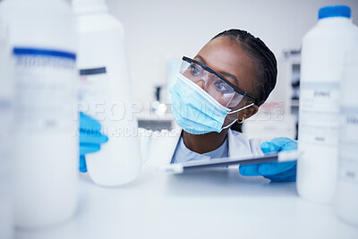 Buy stock photo Stock check tablet, chemical bottle and black woman scientist with mask at pharmaceutical lab. Research, label reading and science of a female worker with manufacturing job and chemistry inventory 