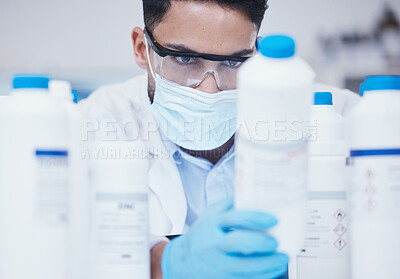 Buy stock photo Stock check, chemical bottle and man scientist with mask at pharmaceutical lab working. Research, container label reading and science of a male worker with manufacturing job and chemistry inventory 
