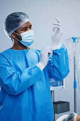 Buy stock photo Doctor in surgery, man in healthcare and surgical procedure start with PPE for safety in operation theatre in hospital. Medical professional, health insurance and male surgeon in protection gear