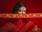 Fashion, eyes and portrait of Indian woman with veil in traditional clothes, jewellery and sari. Religion, beauty and female person on red background with accessory, cosmetics and makeup for culture