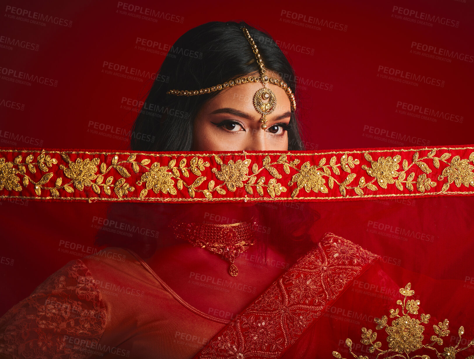 Buy stock photo Fashion, eyes and portrait of Indian woman with veil in traditional clothes, jewellery and sari. Religion, beauty and female person on red background with accessory, cosmetics and makeup for culture