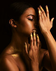 Woman, gold makeup and studio for paint, beauty or body art for creativity, design and black background. Girl, model and skin with metallic texture, pattern or color for cosmetics with dark aesthetic