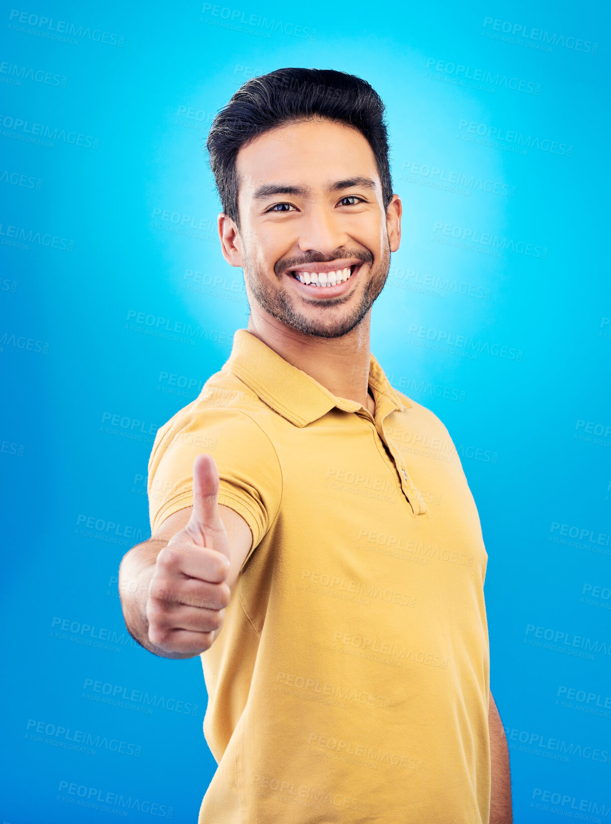 Buy stock photo Thumbs up, success portrait and man on blue background for thank you, winning or yes, like emoji and social media subscribe. Winner, person or asian model in okay, support or good job sign in studio