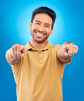 Buy stock photo Portrait, man and pointing to you in studio, blue background and hands for choice of decision, winner and volunteering opportunity. Smile, asian male model and finger emoji for recruitment of hiring